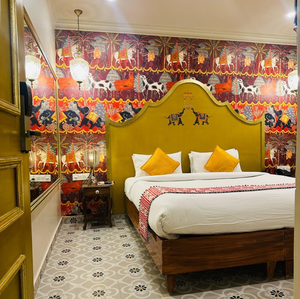 a ac room of staybanaras featuring a neatly made bed, walls adorned with artistic pictures