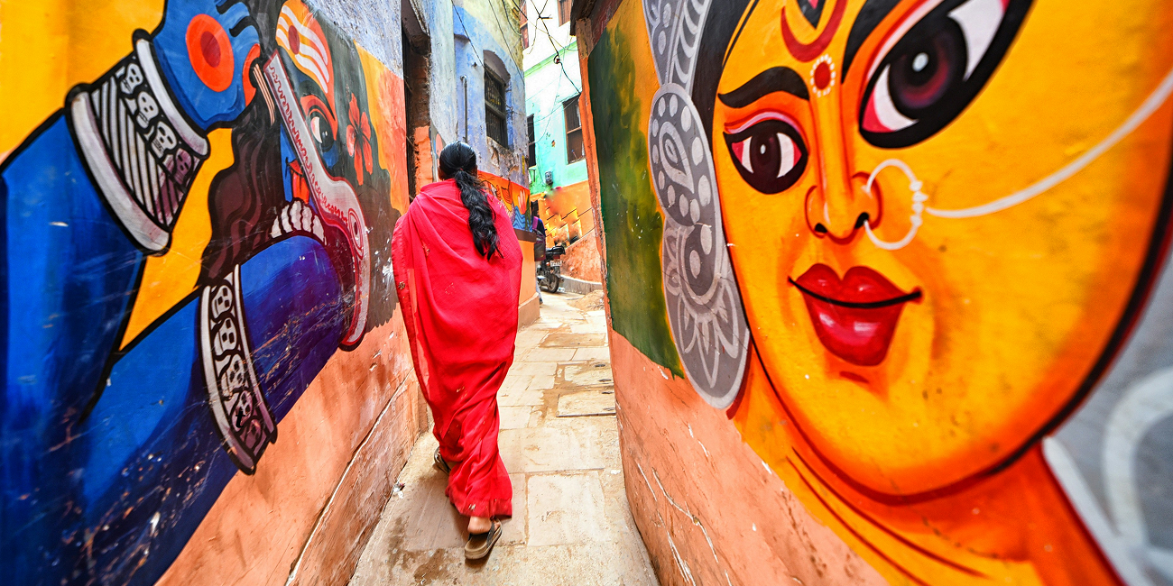 Well decorated wall of Varanasi lane with Gods